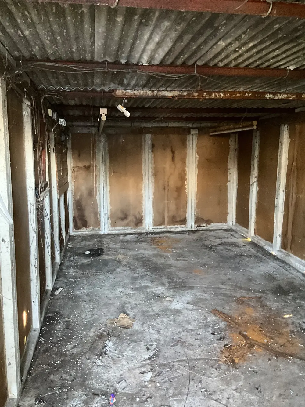 Garage interior in Marple Stockport before asbestos roof and wall panel removal Asbestos Removal Team Ltd