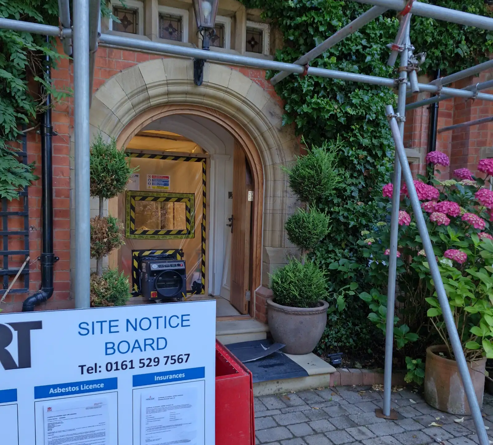 Scaffolding and site notice board in place for a commercial asbestos removal contract Asbestos Removal Team Ltd